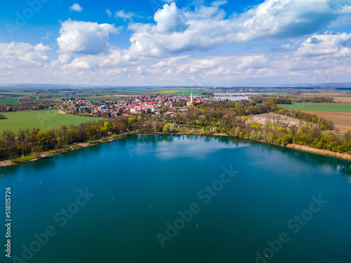 Blue lake in the village with trees © DRONMOVIE