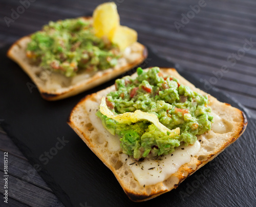 toasted slices of square bread with warm cheese and homemade guacamole on plate for healthy breakfast