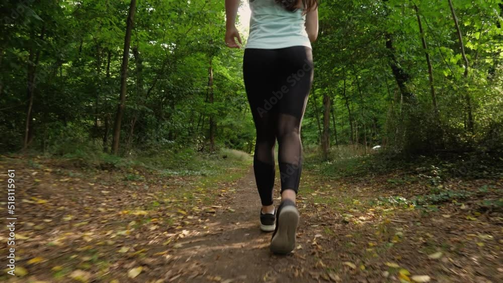 Young woman jogging in the woods