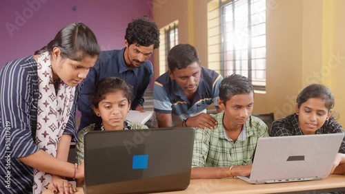 Groups of students seriously using laptop at classroom - concept of technology, education and self learning