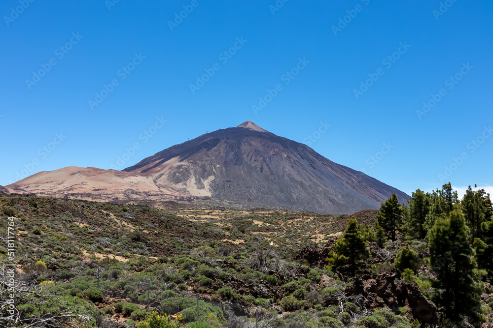Panoramic view on volcano Pico del Teide and Montana Blanca, Mount El Teide National Park, Tenerife, Canary Islands, Spain, Europe. Hiking trail to La Fortaleza from El Portillo. Barren desert terrain
