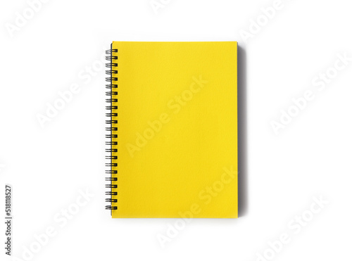 Spiral coil notebook with yellow cover isolated on white with plenty of space around it for creative use. photo