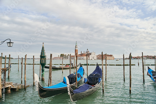Blue gondolas parked in the Venetian lagoon, the Grand Canal in Venice, Italy