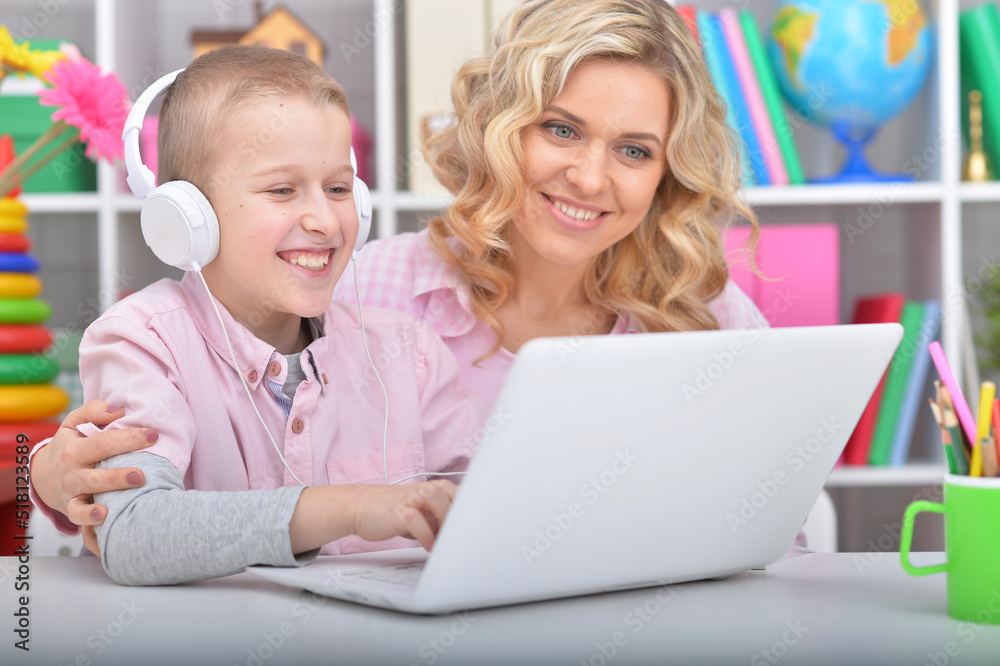Mother and son using laptop