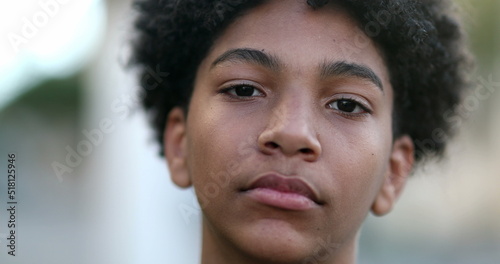 Fotografía Serious mixed race young boy looking at camera