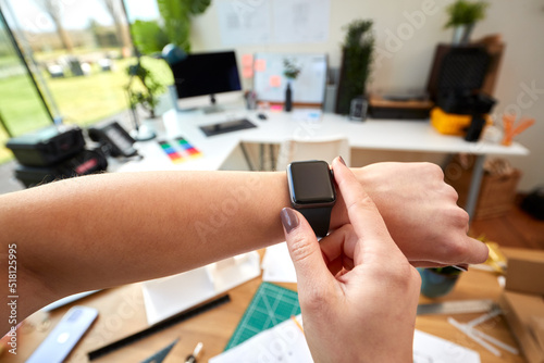 POV Shot Of Female Architect Working In Office Using Smart Watch photo