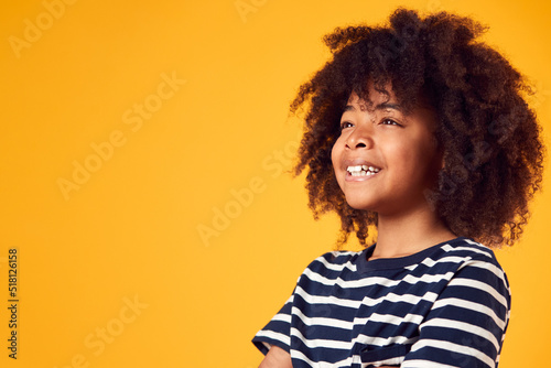 Studio Portrait Of Smiling Young Boy Shot Against Yellow Background © Monkey Business