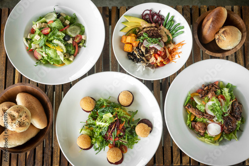 several different fresh salad dishes on restaurant table © TravelPhotography