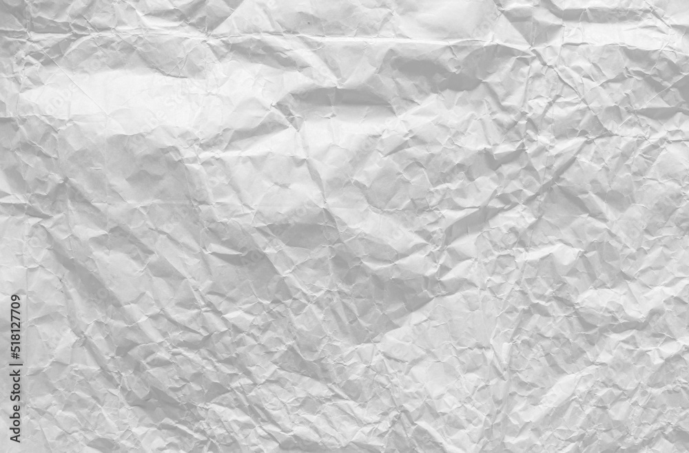 Fototapeta premium Top view of crumpled white paper for the background. Light and soft color background, large crumpled paper background texture for art design. The surface is not smooth but attractive.