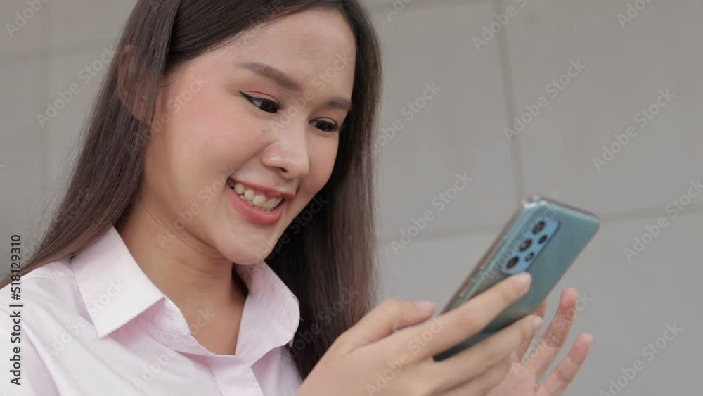 Businesswoman holding a smartphone talking to customers. Use of modern communication technology. office worker Businesswoman holding a smartphone talking to customers. Use of modern communication technology. office worker