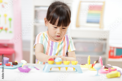 young girl making food using dough tools for homeschooling