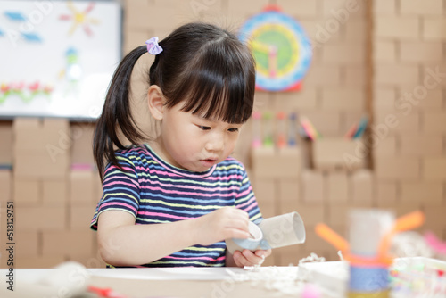 young girl making craft for homeschooling