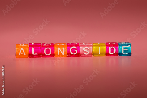 the word "alongside" made up of cubes