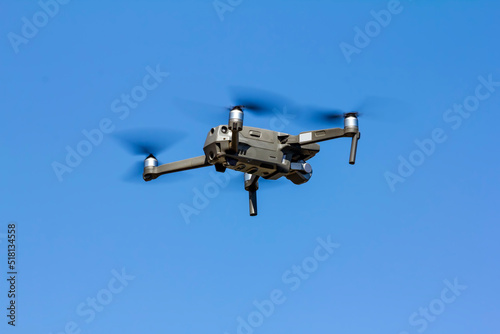  View on quadcopter drone flying in the blue sky.