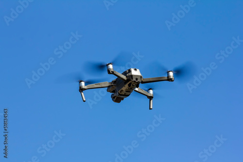 View on quadcopter drone flying in the blue sky.