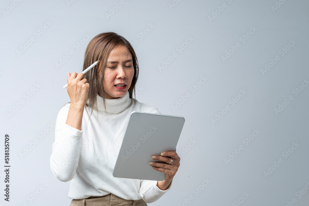 Asian woman in white shirt holding tablet in studio against white background Asian woman in white shirt holding tablet in studio against white background