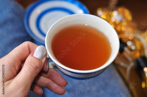 close up of cup of tea with blue stripes at home ,teatime and relax
