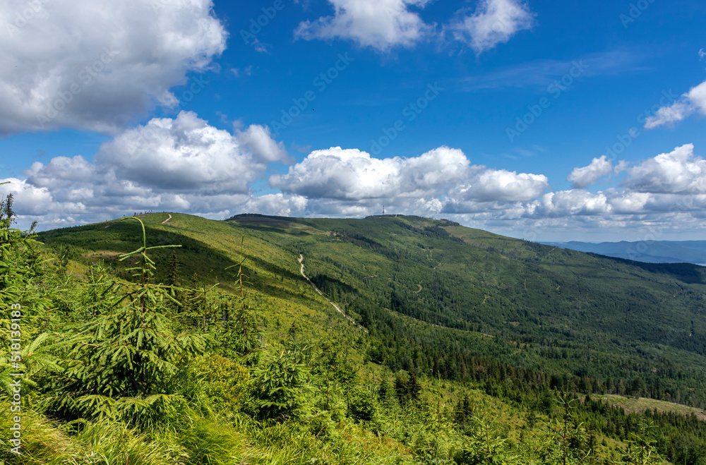 Mountain landscape against blue sky and white clouds