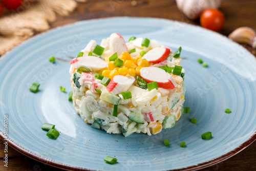 salad with crab meat and tomatoes on old wooden table