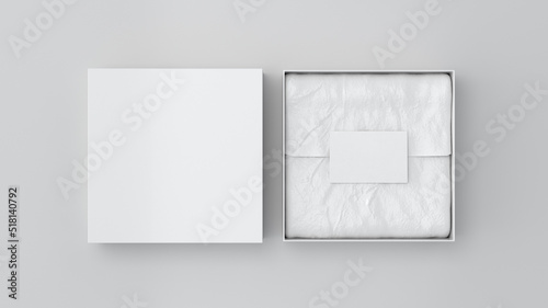 Square gift box mock up. White gift box with blank label or business card on wrapping paper. White background. View directly above.