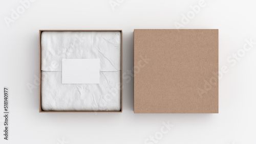 Square gift box mock up. Cardboard gift box with blank label or business card on wrapping paper. White background. View directly above.