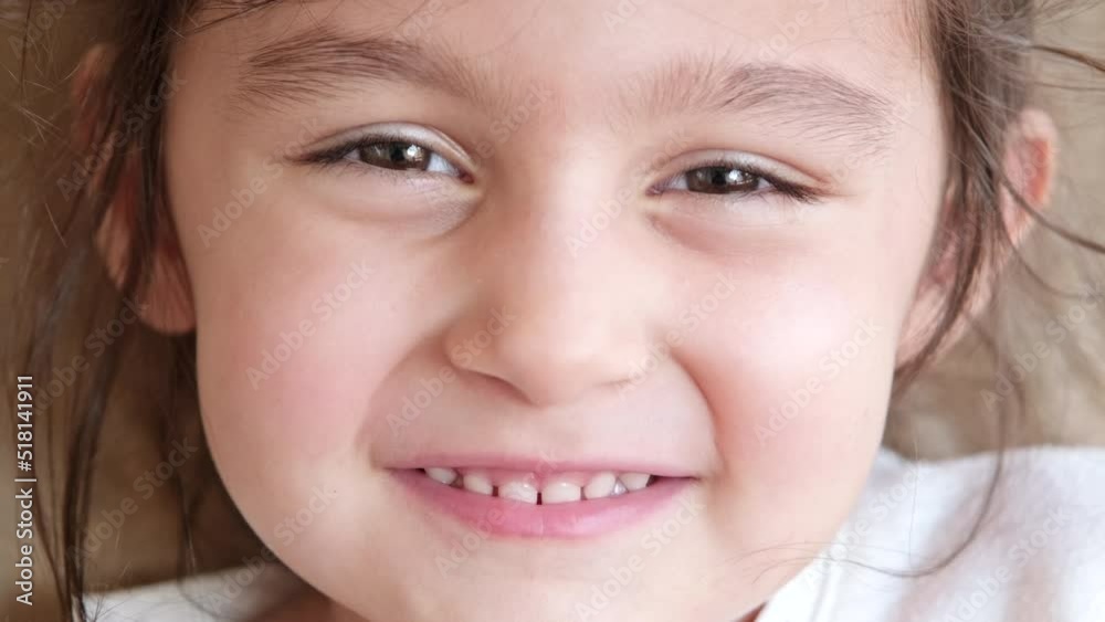 Authentic shot of cute little girl is looking camera. Close-up Authentic shot of cute little girl is looking camera. Close-up