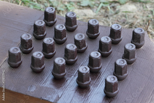 Ground painted rusty car wheel nuts renovation photo