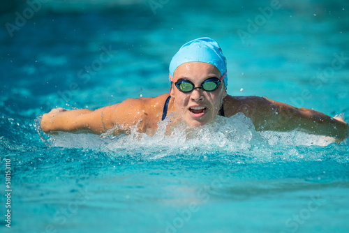 Young woman swimming butterfly stroke
