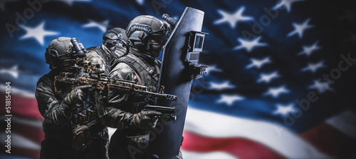 Fotografija Armed special forces group on the background of the American flag