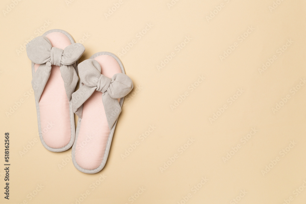 Soft pink slippers on color background, top view Soft pink slippers on color background, top view