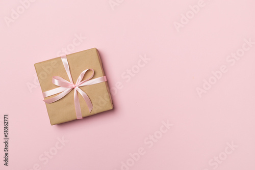 Craft gift box on color background, top view