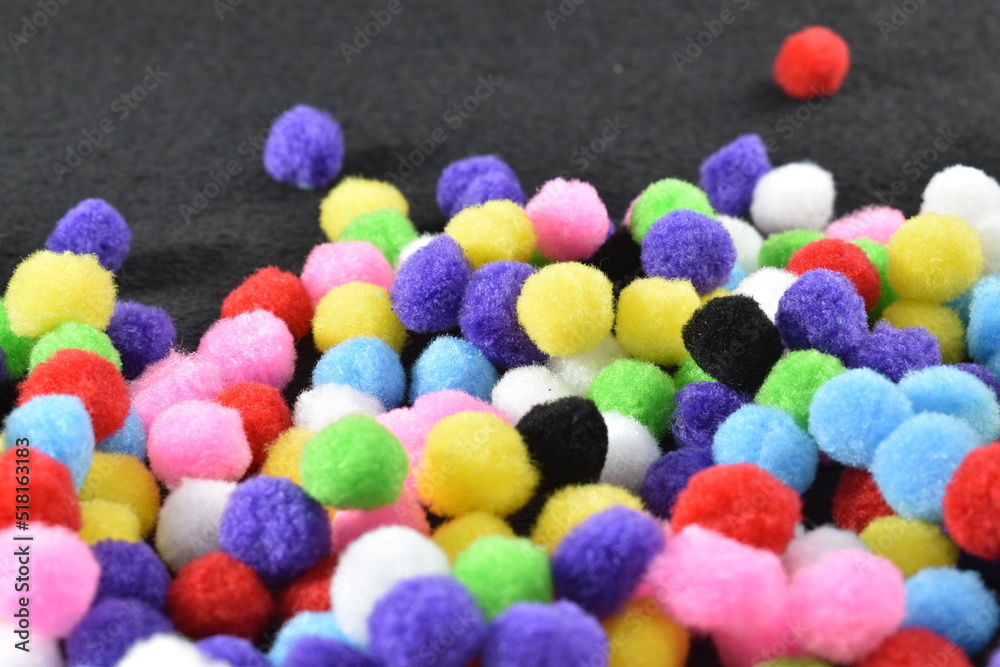 multicolored balls of wool on a black background multicolored balls of wool on a black background