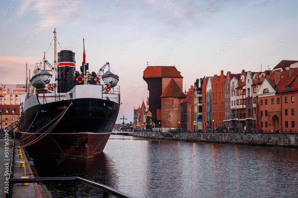 Gdansk, Poland. Polish old town and Motlawa river with ship during sunrise. Eastern Europe travel destination at Baltic sea