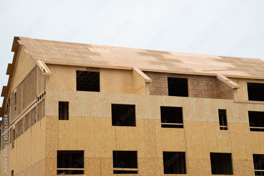New residential frame house under construction New residential frame house under construction
