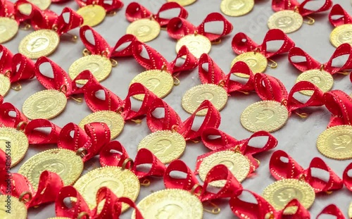 Turkish quarter gold coin with red ribbon, close up