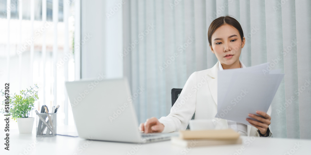 Asian businesswoman working on laptop and mobile phone Start up small business owner. business successful technology concept Asian businesswoman working on laptop and mobile phone Start up small business owner. business successful technology concept