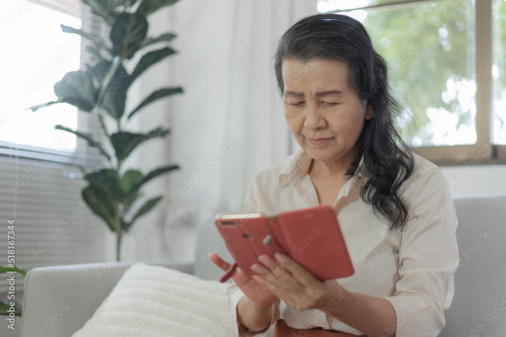 Happy Asian senior elderly old woman using mobile phone receiving new message on smart phone Happy Asian senior elderly old woman using mobile phone receiving new message on smart phone