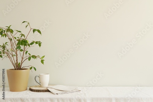 Wallpaper Mural Empty wall mockup for design or art presentation, shelf with linen tablecloth, flower in the pot and coffee cup, minimalist interior. Torontodigital.ca