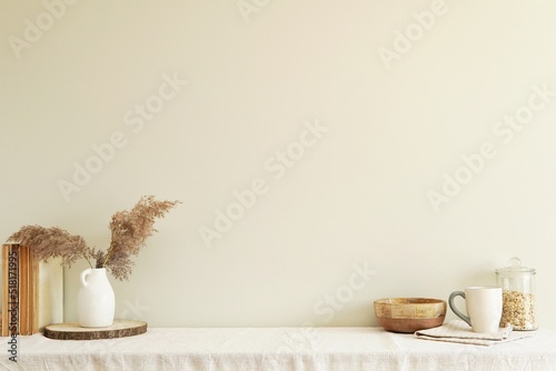 Scandinavian bohemian style interior composition on table with linen tablecloth  old books  pampas grass  blank wall mockup for wall art or photography presentation.