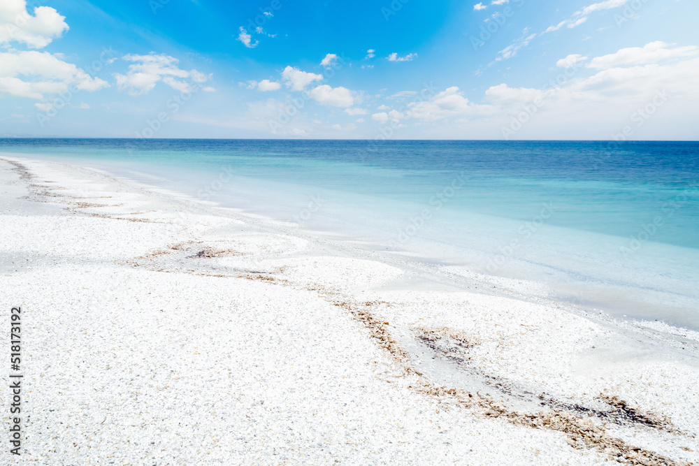 White pebbles and blue sea in Stintino shore White pebbles and blue sea in Stintino shore