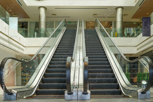 Escalators in an office building or mall. Empty escalator stairs. Modern escalator in shopping mall, Department store escalator. Empty escalator inside building