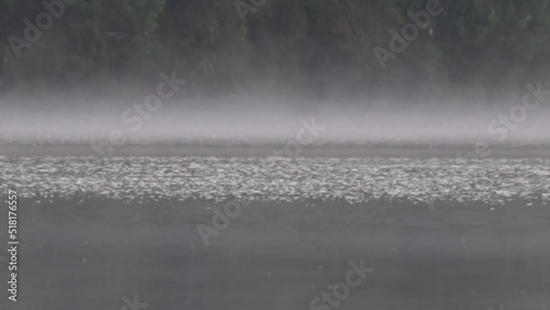 Peaceful Morning at Situ Patengan Patenggang Lake in Ciwidey Bandung West Java Indonesia - Steam Fog Above The Water photo