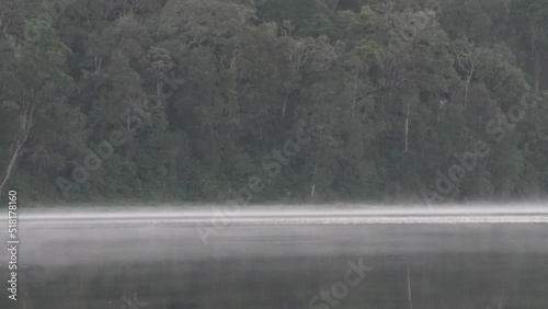 Peaceful Morning at Situ Patengan Patenggang Lake in Ciwidey Bandung West Java Indonesia - Steam Fog Above The Water photo