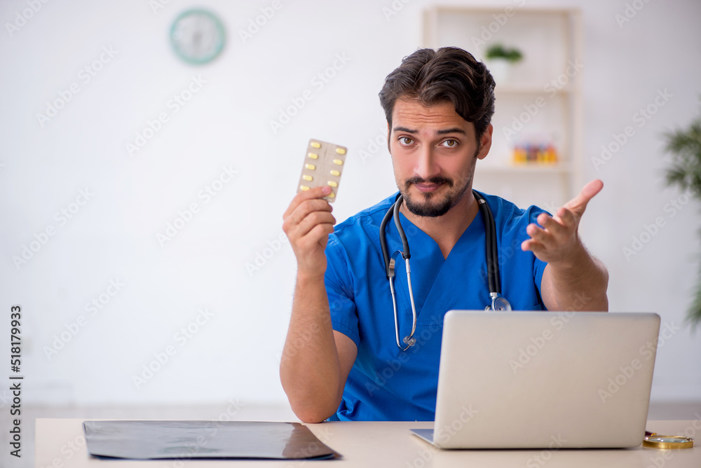 Young male doctor working in the clinic Young male doctor working in the clinic