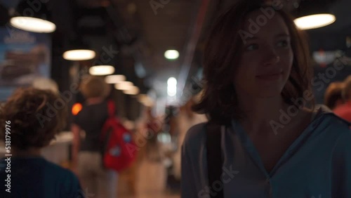 Cheerful woman walking city food court restaurant food market and caffe indoors. Caucasian female traveler walk discover city life. Beautiful middle age woman enjoy 