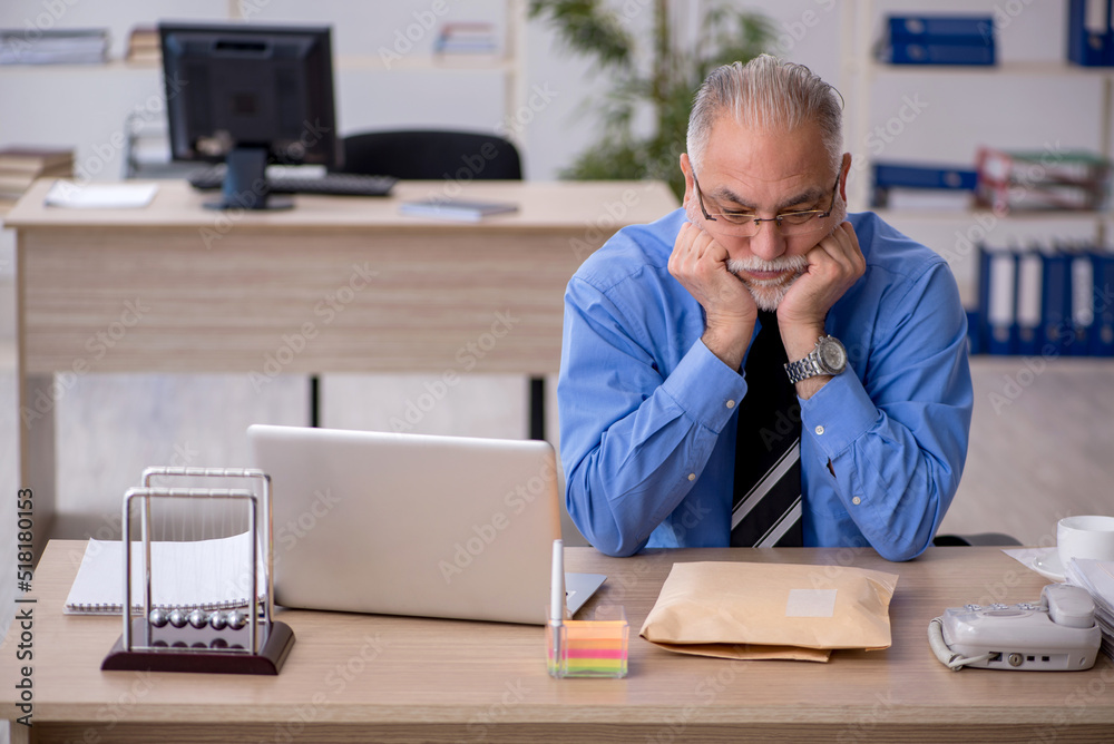 Old male employee receiving parcel via Internet