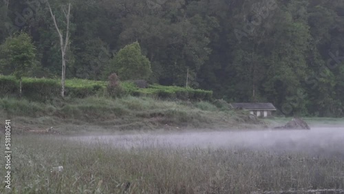 Peaceful Morning at Situ Patengan Patenggang Lake in Ciwidey Bandung West Java Indonesia - Steam Fog Above The Water photo