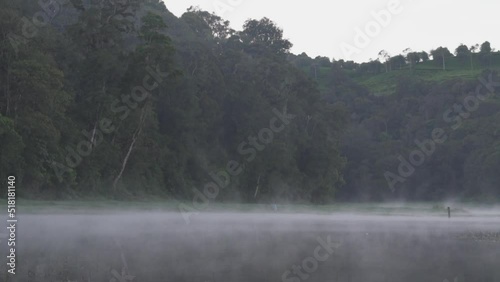 Peaceful Morning at Situ Patengan Patenggang Lake in Ciwidey Bandung West Java Indonesia - Steam Fog Above The Water photo