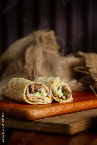 Spring rolls with sweet chilli sauce and chicken or beef on wooden set