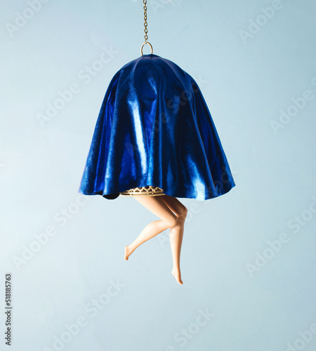 Slika na platnu Bird cage covered with blue fabric, doll's legs exposed